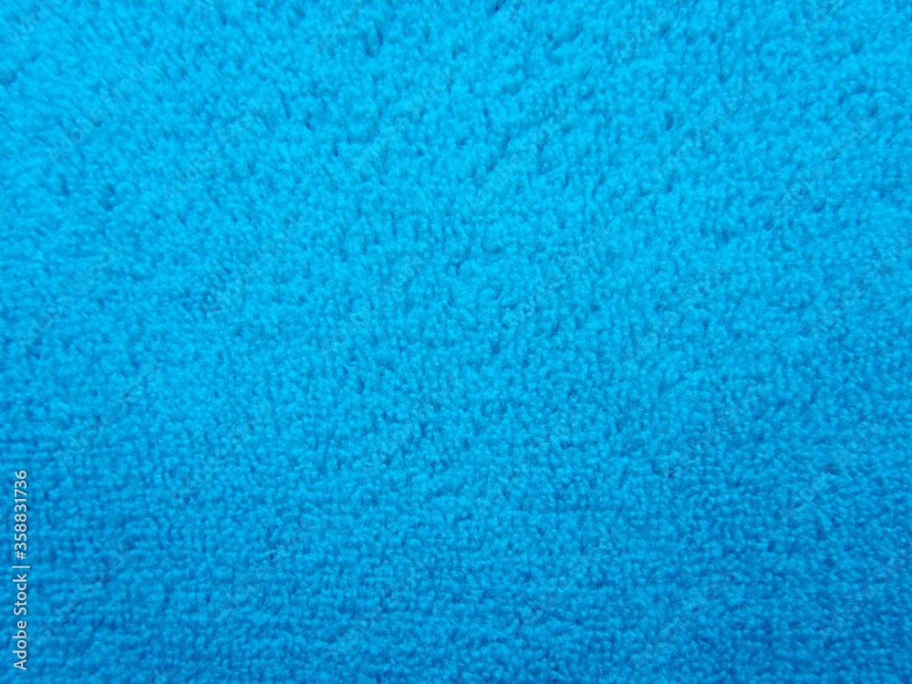 Blue pile fabric draped with pleats. Fabric made from natural fibers. Blue pile fabric draped with pleats. Fabric made from natural fibers.