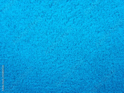 Blue pile fabric draped with pleats. Fabric made from natural fibers.