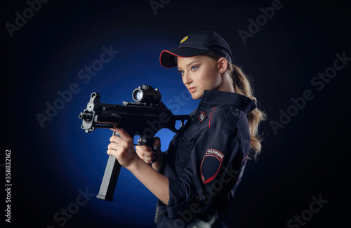 the girl in the police uniform with a gun is a Russian policeman with gun. English translation of   Police 