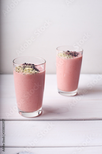 Two strawberry raspberry smoothies with hemp seed topping