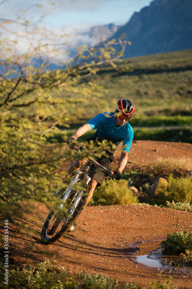 Close up image of a mountain biker speeding downhill on a mountain bike track Close up image of a mountain biker speeding downhill on a mountain bike track