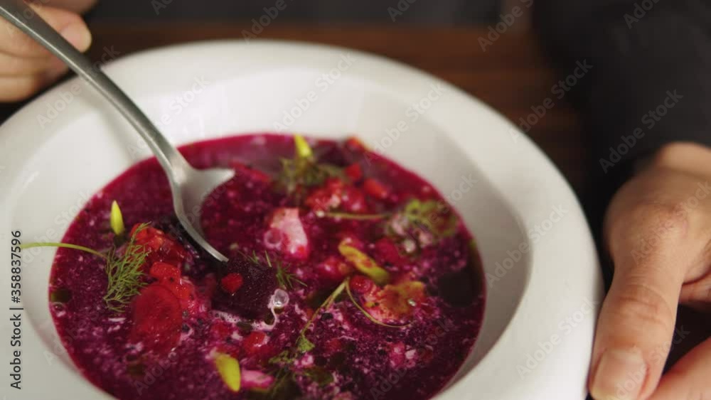 Traditional Ukrainian Russian borscht soup with white beans on the bowl. Plate of red beetroot soup borsch, Traditional Ukraine food high gourmet haute cuisine by chef