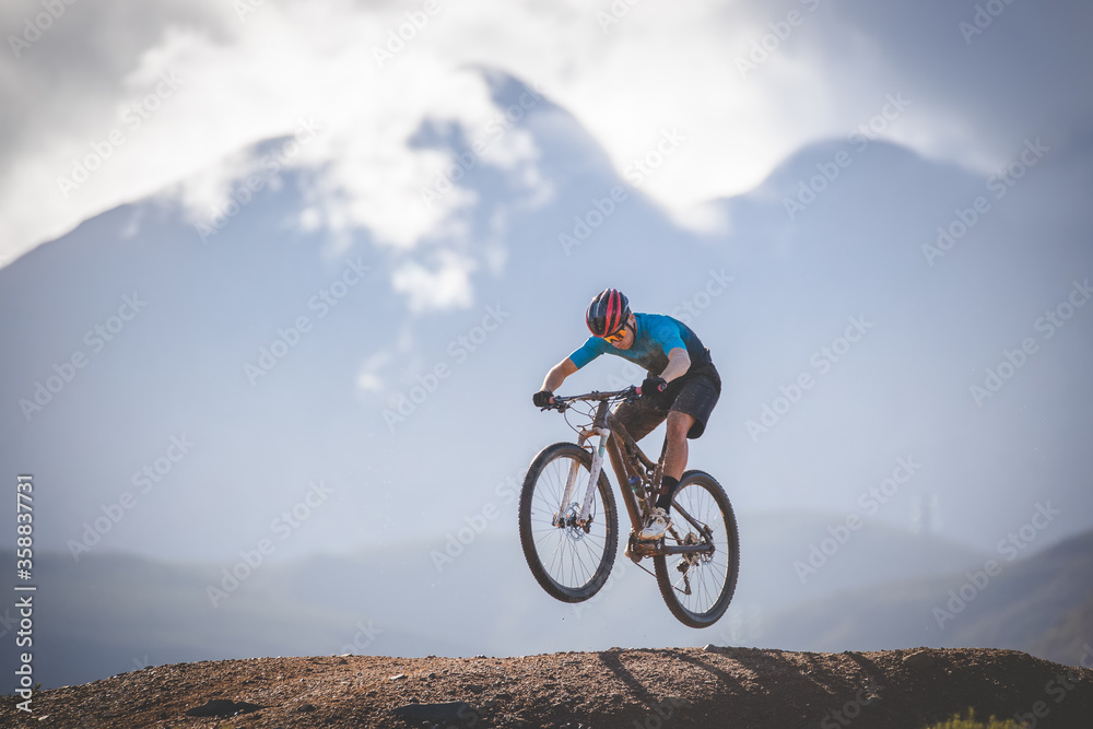 Close up image of a mountain biker speeding downhill on a mountain bike track