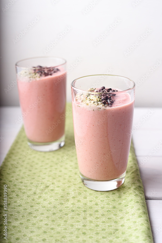 Two strawberry raspberry smoothies with cocoa bean topping Two strawberry raspberry smoothies with cocoa bean topping