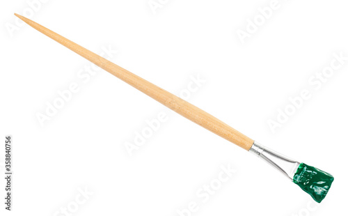 flat paint brush with green colored tip and long wooden handle isolated on white background