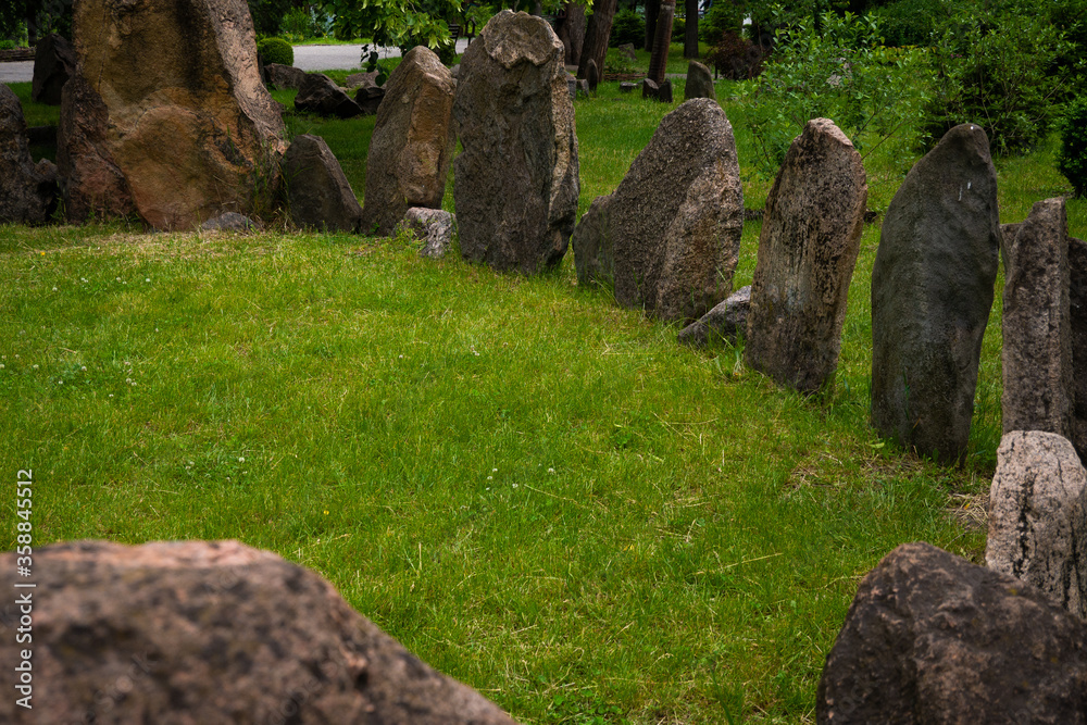 Megalithic stone circle Kriviy Rih city, Ukraine, city park. Summer time. Juicy grass among the ancient pagan sanctuary Megalithic stone circle Kriviy Rih city, Ukraine, city park. Summer time. Juicy grass among the ancient pagan sanctuary