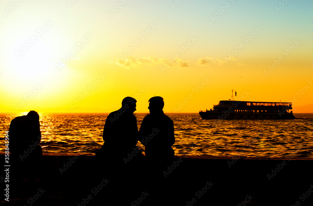 People Silhouette and the Sea in Sunset