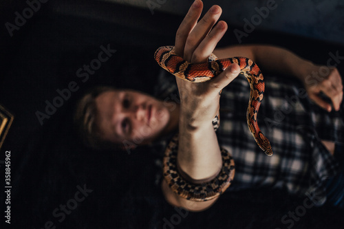 Beautiful tortoise snake in her arms.