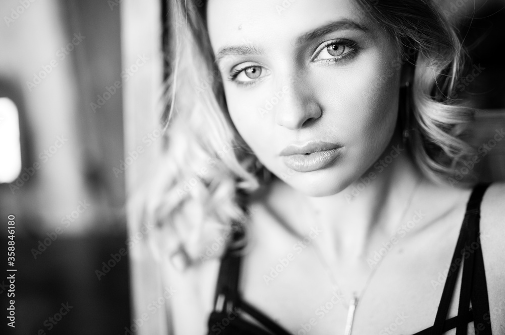 Close up monochrome portrait of curly blond charming woman. Close up monochrome portrait of curly blond charming woman.