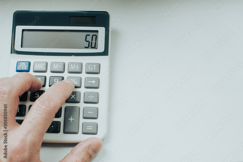 hand holding calculator on white background hand holding calculator on white background