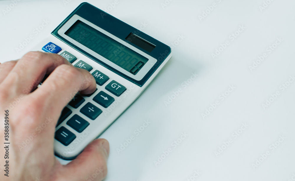 hand with calculator on white background hand with calculator on white background
