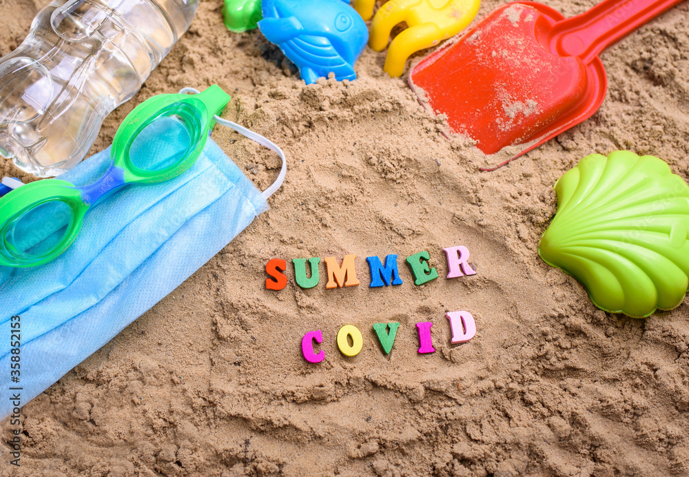 Beach sand, children's sand toys, face masks. Summer coronavirus. Covid-19 Beach sand, children's sand toys, face masks. Summer coronavirus. Covid-19