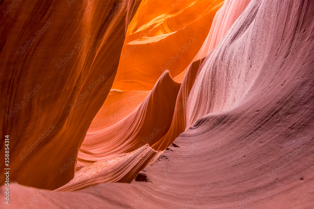 Wave shapes eroded into the high-level glowing walls in lower Antelope Canyon, Page, Arizona