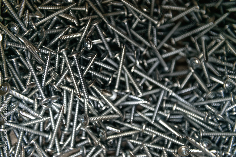Background of metal nails top view close-up. Background from a variety of building steel sharp nails macro. A big pile of nails. Гвозди. Шурупы. Background of metal nails top view close-up. Background from a variety of building steel sharp nails macro. A big pile of nails. Гвозди. Шурупы.