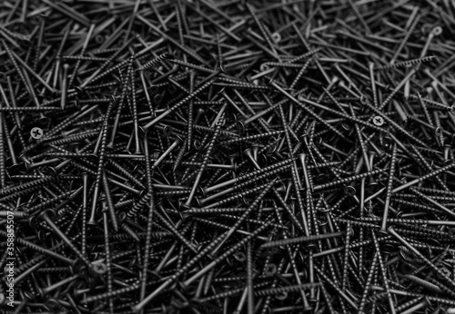Background of metal nails top view close-up. Background from a variety of building steel sharp nails macro. A big pile of nails. Гвозди. Шурупы. 