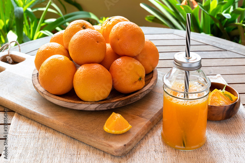 orange juice with freshly picked oranges in a rustic setting