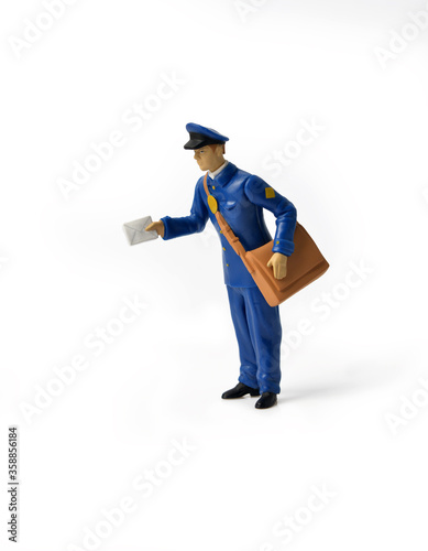 online purchases. Miniature mailmen figurine presents a letter. home delivery. Keep the distance to avoid contagion. Social distance concept for epidemic safety. Covid-19 and Coronavirus