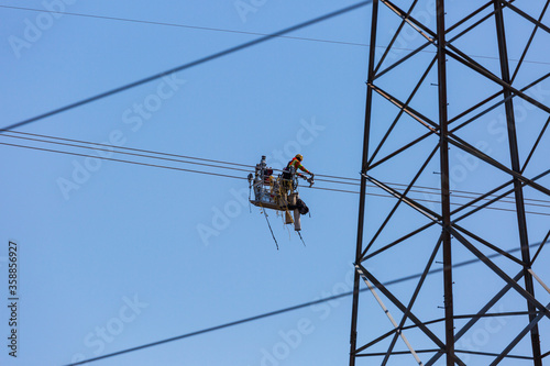 Line workers installing spacer dampers on high voltage power conductors.  Several scenes shot at each location to capture this detailed task.