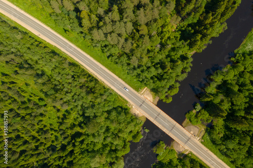 Aerial high angle view of highway and bridge over river in deep forest, Moscow area, Russia