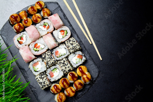 Sushi. Bonito rolls, classic and bake rolls on the dark background. Sushi food photo for menu. Combo set of rolls Sushi