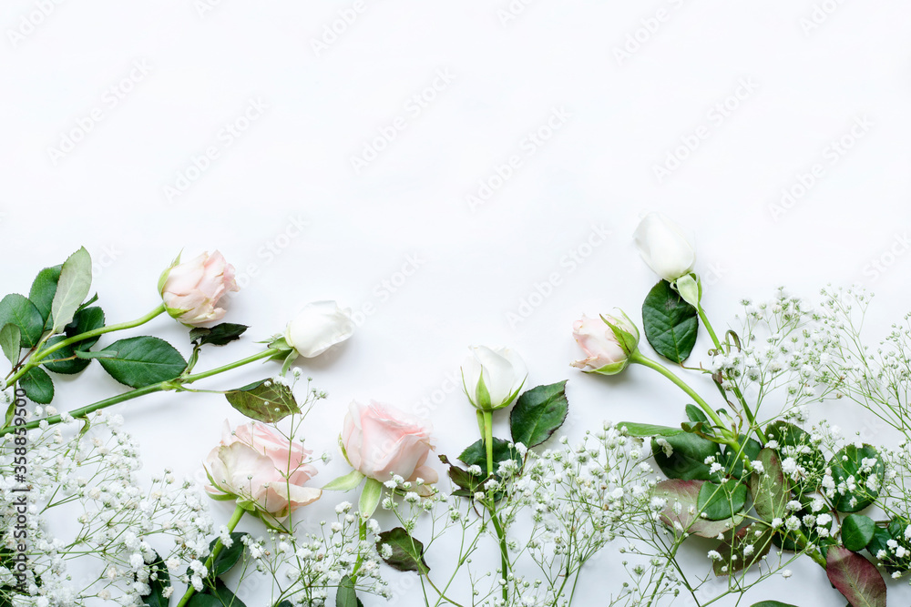 Fototapeta premium pink rose and wedding rings over white background