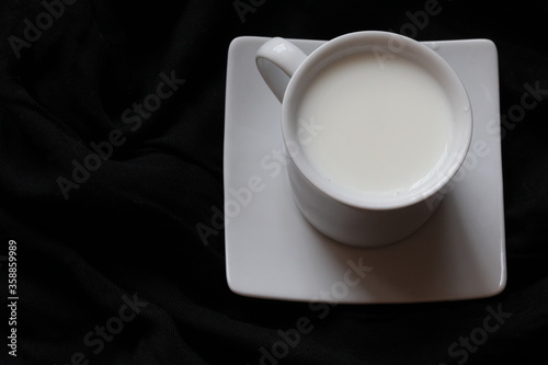 Home cozy composition. Cup of milk on black background. Fall background. Flat lay  top view  copy space