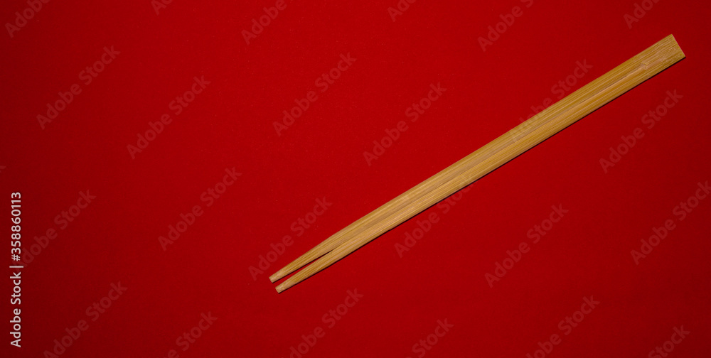Chopsticks for oriental or asian food on a red background Chopsticks for oriental or asian food on a red background