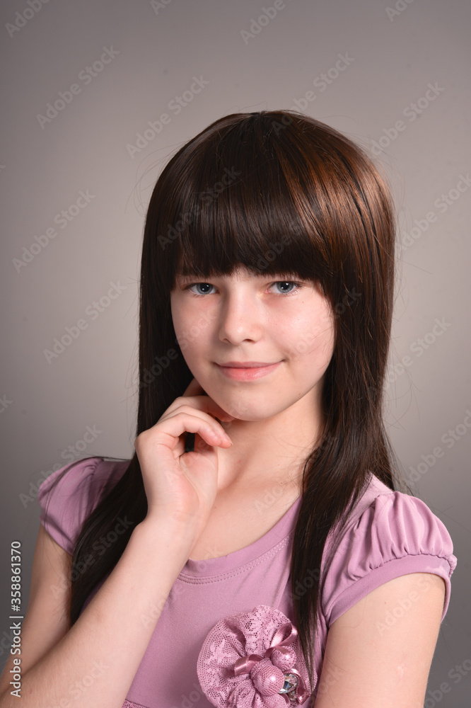 Portrait of beautiful girl posing in studio on background Portrait of beautiful girl posing in studio on background