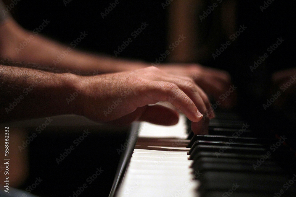 Hands playing piano in close up Hands playing piano in close up