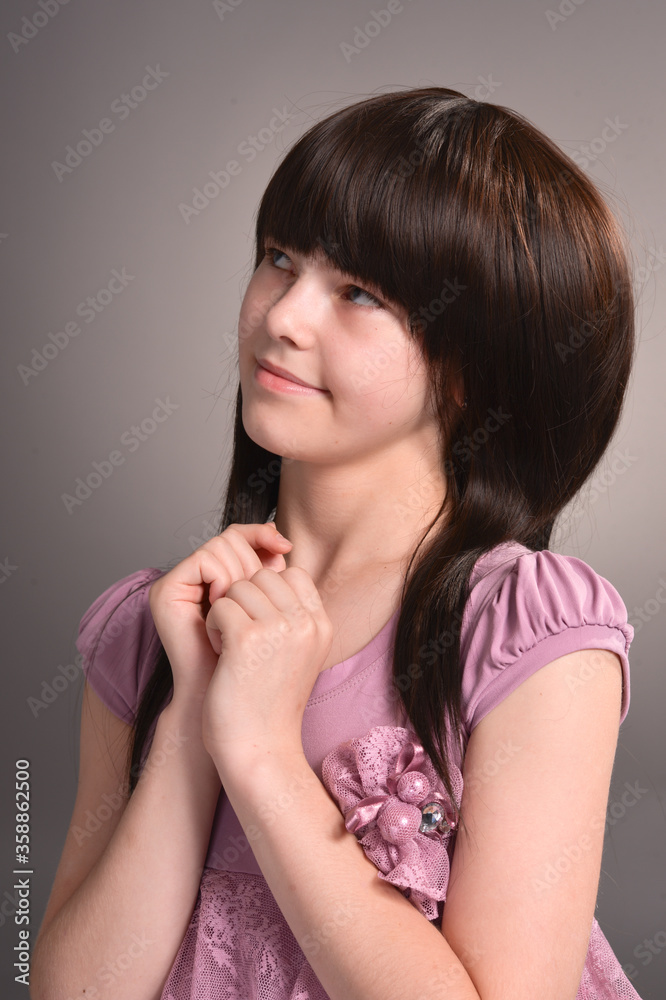 Portrait of beautiful girl posing in studio on background