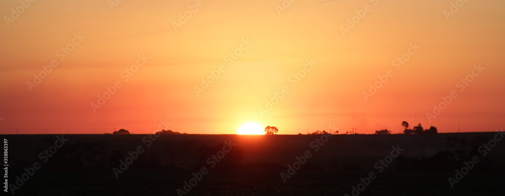 Sunset over the field at the golden hour. Panoramic landscape. Sunset over the field at the golden hour. Panoramic landscape.