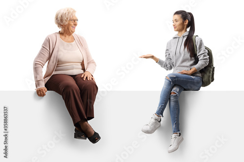Female student on a panel talking to an elderly lady