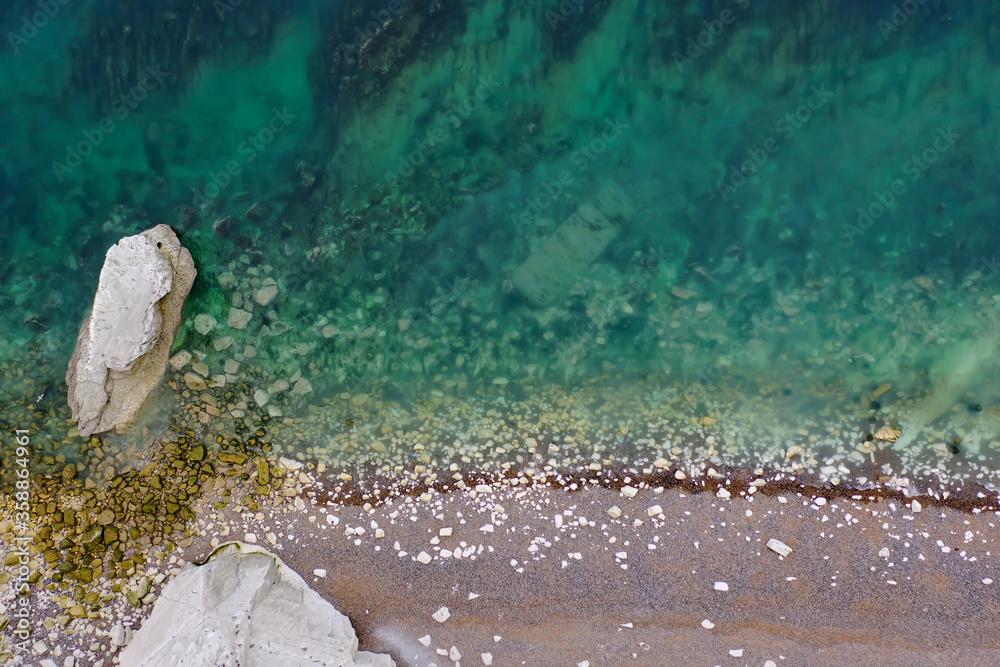 colorful abstract marine background photo with emerald green sea and a beautiful beach 