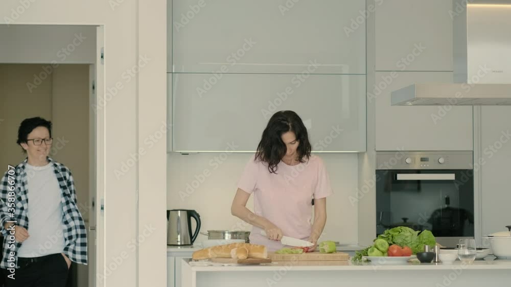 female cooking food in kitchen, friend girlfriend coming and tasting salad Pbbro. lesbian couple domestic life. adult woman preparing cooking vegetables. lgbt married family female cooking food in kitchen, friend girlfriend coming and tasting salad Pbbro. lesbian couple domestic life. adult woman preparing cooking vegetables. lgbt married family