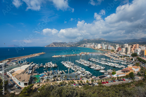 Summer view of Calpe town, Calp, with harbor and beach and  Penon de Ifach mountain,  Marina Alta, province of Alicante, Valencian Community, Spain © tsuguliev