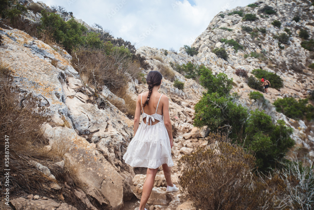 Naklejka premium View of Calpe Calp town with Penon de Ifach mountain during the hiking to Penyal d'Ifac Natural Park, Marina Alta, province of Alicante, Valencian Community, Spain