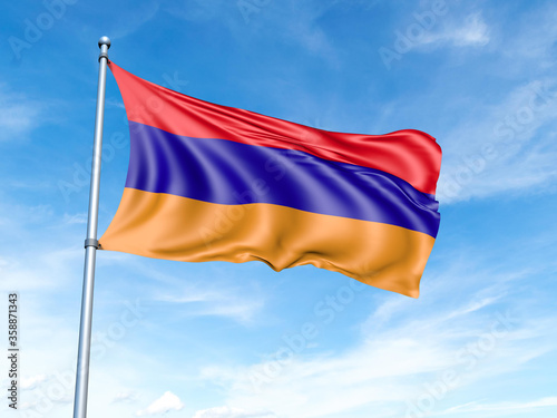 Armenia flag on a pole against a blue sky background.