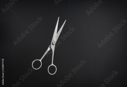 Professional scissors on black background 