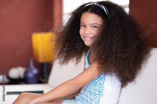 Cute multiracial small girl with beautiful curly hair