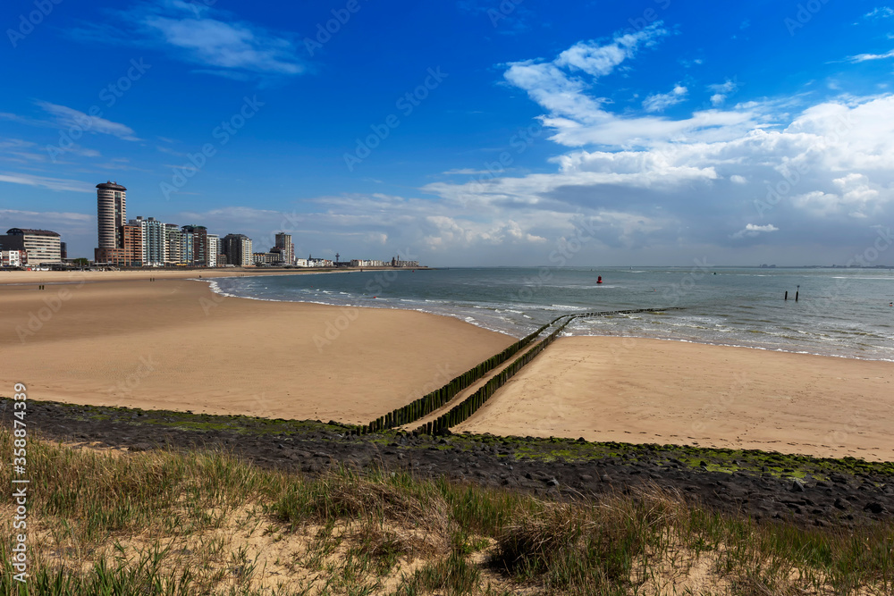 Vlissingen - a beautiful sandy bay with a wooden breakwater and a coastal promenade of standing houses, hotels and restaurants.