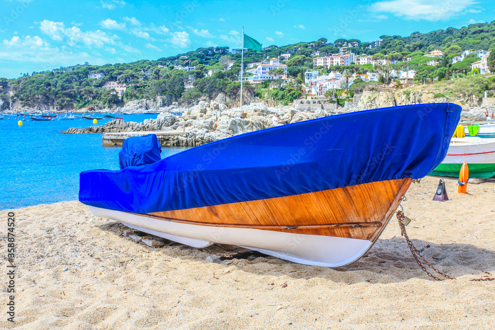 Fishing boat covered with a blanket on the beach