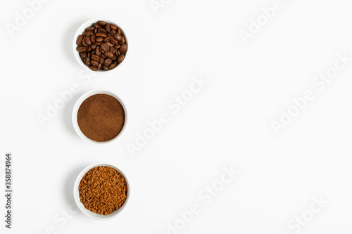 coffee beans, ground and black coffee or espresso in mugs on a white background. concept of different types and choices. coffee shop or store concept. flat lay, top view, minimalism, copy space..