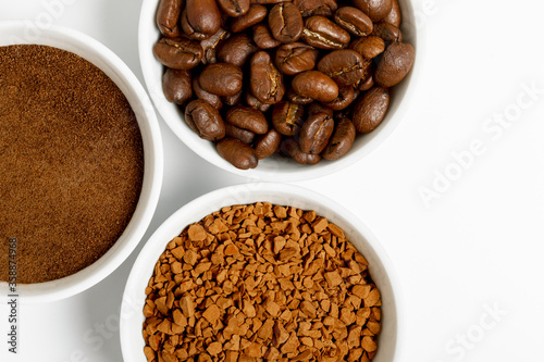 coffee beans, ground and black coffee or espresso in mugs on a white background. concept of different types and choices. coffee shop or store concept. flat lay, top view, closeup.
