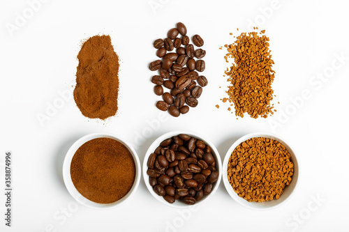 coffee beans, ground and black coffee or espresso in mugs and sprinkled on a white background. coffee shop or store concept. flat lay, top view.