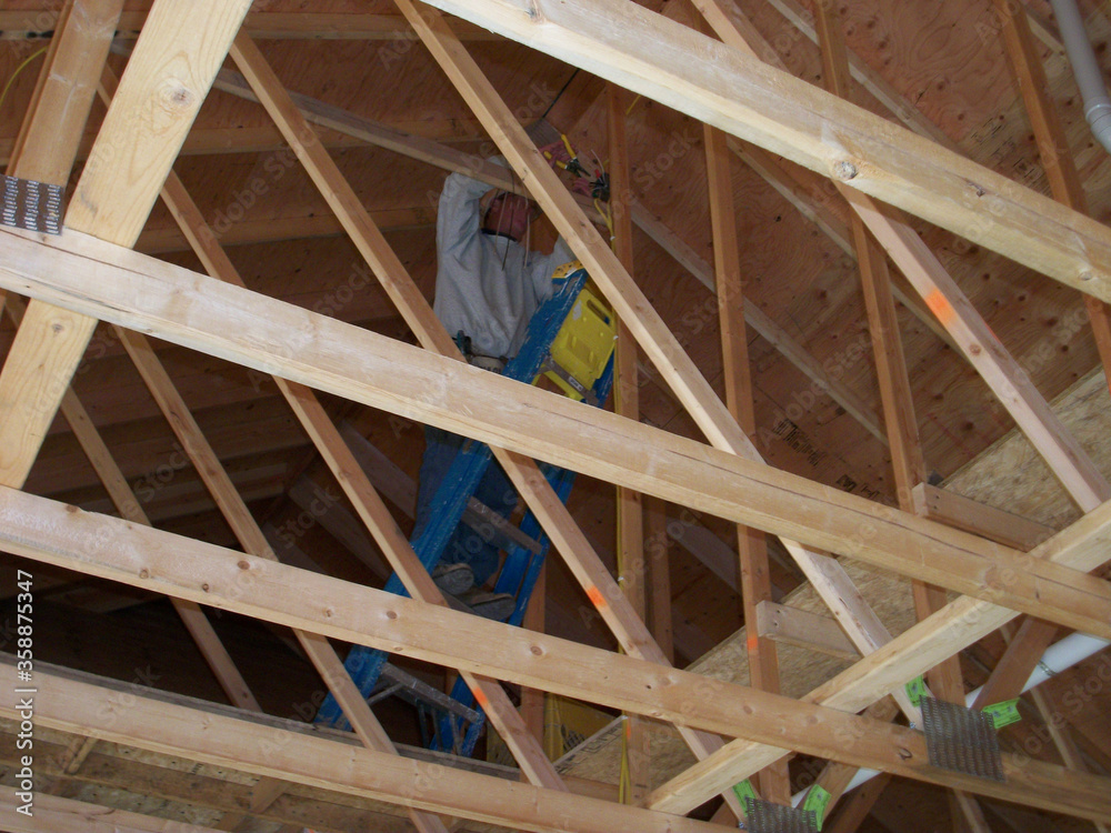 Installation of rafter beams in new house attic. Installation of rafter beams in new house attic.