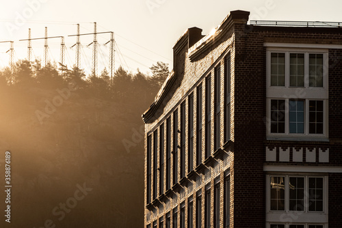 Sun shining on an old industrial building.
