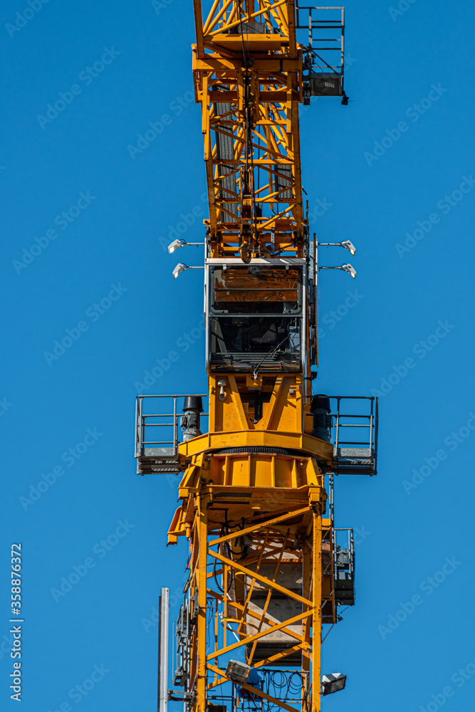 Details of a tall yellow construction crane Details of a tall yellow construction crane