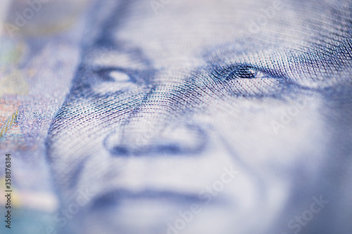 Horizontal marco detail of the image of Nelson Mandela in the obverse of South African ZAR banknote with a denomination of 100 rand. photo
