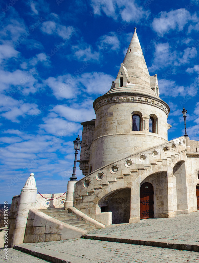It's Fisherman's Bastion, on the Buda bank of the Danube, on the Castle hill in Budapest, around Matthias Church. It's Fisherman's Bastion, on the Buda bank of the Danube, on the Castle hill in Budapest, around Matthias Church.