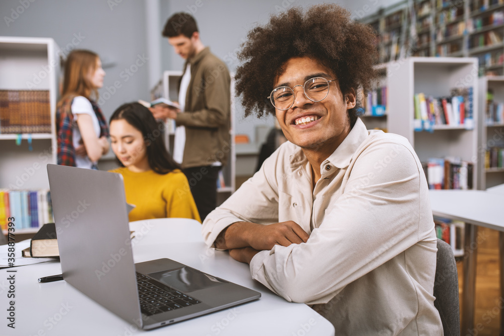 University students are studying in a library together. Concept of teamwork and preparation University students are studying in a library together. Concept of teamwork and preparation